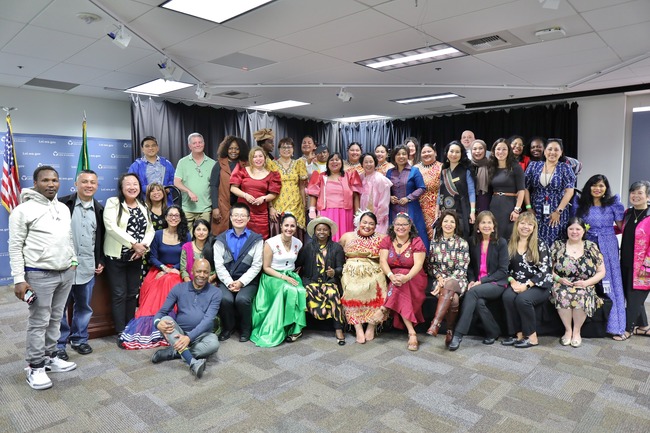 Approximately 40 attendees standing together during the Immigrant Heritage Celebration event. 