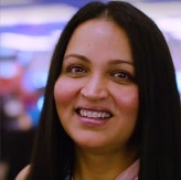 Titu Hariharan, a South Asian woman with tan skin and long dark hair