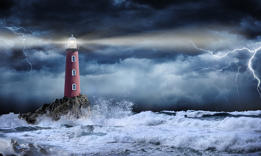 Lighthouse shining its light in the midst of a storm 