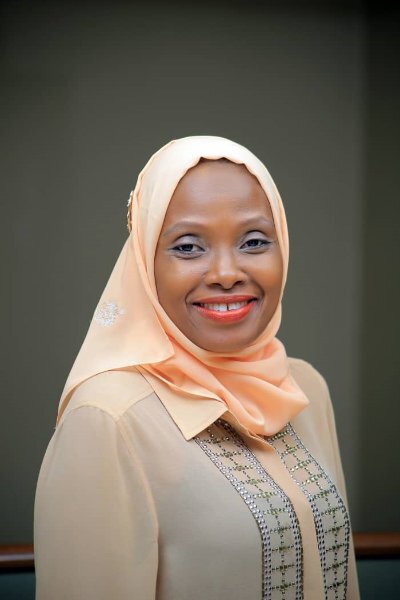 New WIN Co-Vice Chair Janet Nambi Kiwanuka wearing a peach-colored head scarf
