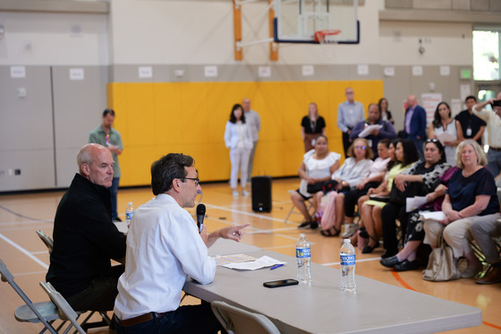 U.S. Rep. Rick Larsen, left, and Governor Bob Ferguson speak to families and school officials at Lynnwood Elementary School on Aug. 21.