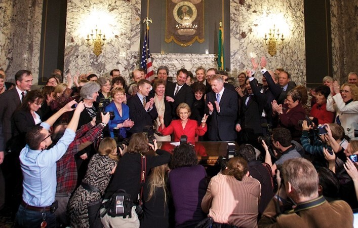 Governor Gregoire Signs Civil Marriages and Domestic Partnership Bill Law, surrounded by advocates