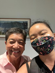 Two people smile together at an event hosted by the LGBTQ Commission.