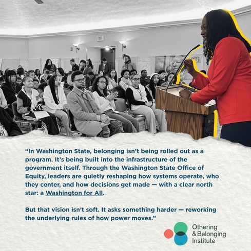 Decorative. Image of Megan speaking to a room of people.