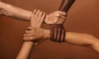 Four hands folded together