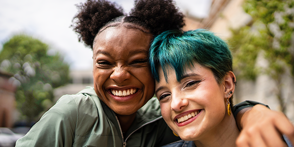 Two cheerful young people embrace