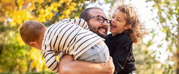 Happy dad and two kids playing outside