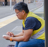 person wearing reflective vest at bus stop