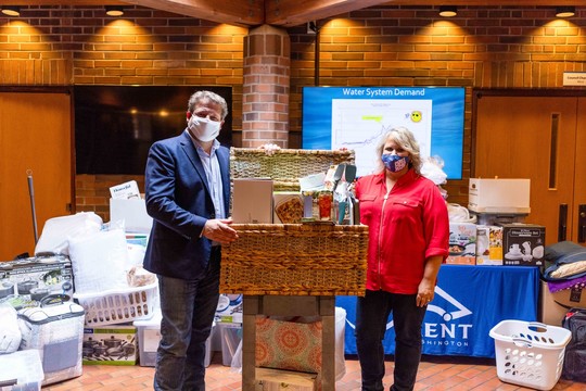 Mayor Ralph and King County Councilmember Reagan Dunn in front of donations at Kent City Hall