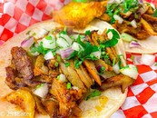 Al pastor tacos and pineapple from El Piketon Restaurant and Lounge.