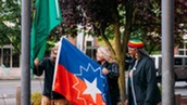 Mayor Ralph and Gwen Allen-Carston, Executive Director of the Kent Black Action Commission, raise the Juneteenth flag at Kent City Hall