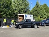 Mini Recycling Event, truck in front of Recycling Center pickup vehicle and workers loading items