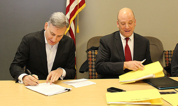 King County Executive Dow Constantine and Local Services Department Director John Taylor sign four partnership agreements