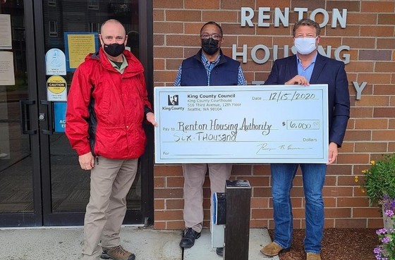Dunn delivers check to Renton housing Authority
