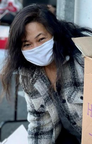 Woman wearing mask unpacking boxes
