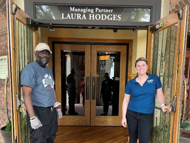 Kenneth Smith and Laura Hodges in front of the Outback Steakhousewhere Smith now works.
