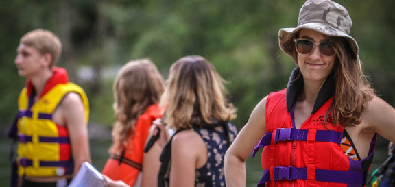 People wearing life vests in an outdoor setting
