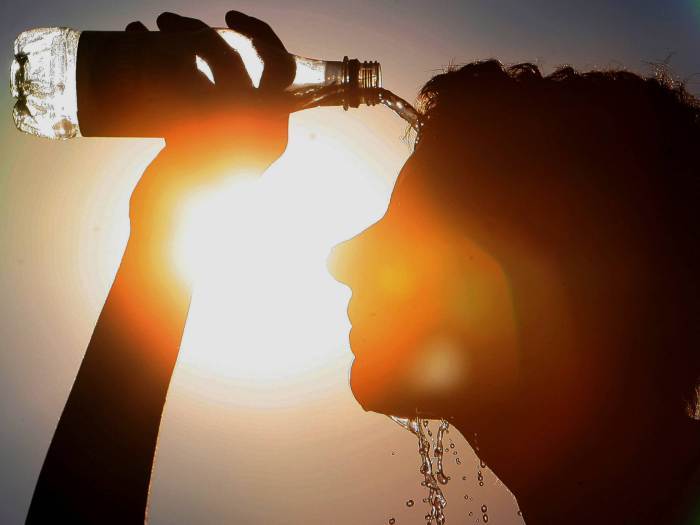 woman pouring water on head