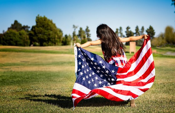 girl with flag - Photo by vivek kumar on Unsplash