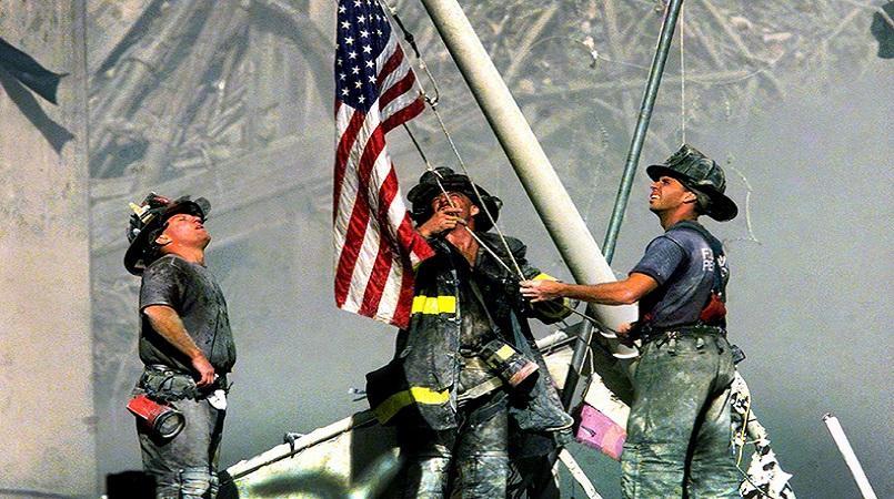 firefighters with flag on 9-11