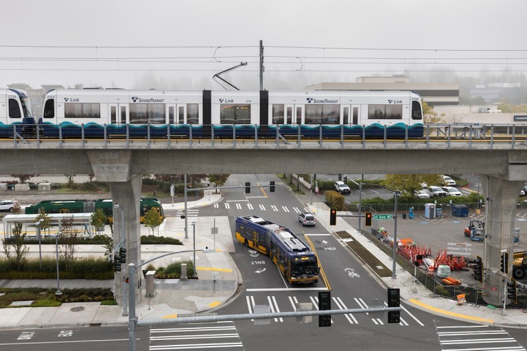 A sound light-rail train leaves the Northgate station as a King County Metro bus passes underneath on Oct. 2, 2021 in Seattle.