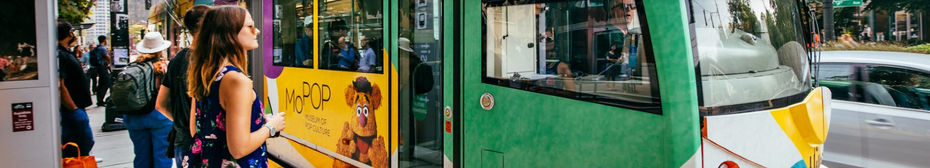 Picture of riders boarding a streetcar at a stop.