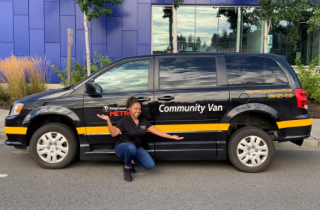 Community Van Coordinator and Skyway native Kahdijah Jackson in front of a community van