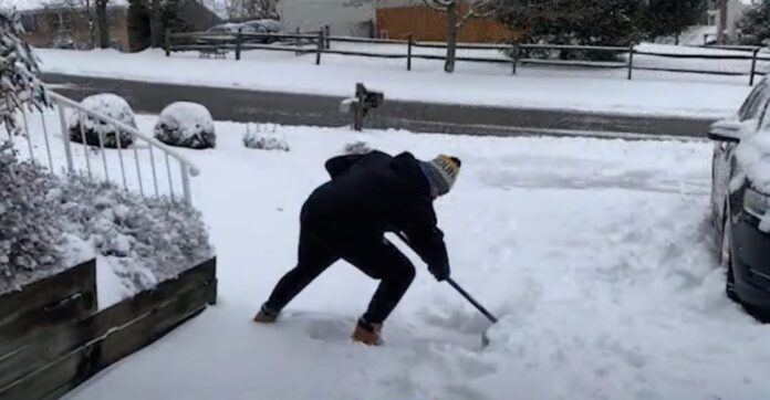 teen shoveling snow