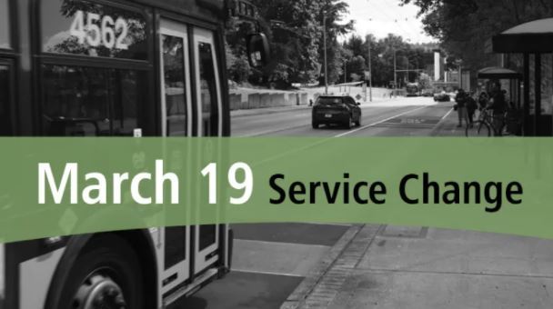 black and white image of a bus pulling up to a stop with a green banner that has the text "March 19 Service Change"