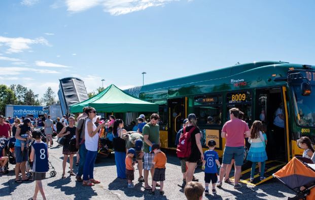 The Seattle community comes together at a previous Junior League of Seattle’s Touch-A-Truck event to explore King County Metro vehicles.