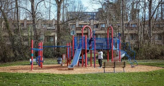 Skyway park play area, with a parent and a child