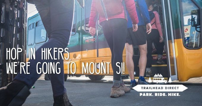 Image od the waist down of riders boarding the Trailhead Direct bus "Hop in Hikers, we're going to Mount Si!"