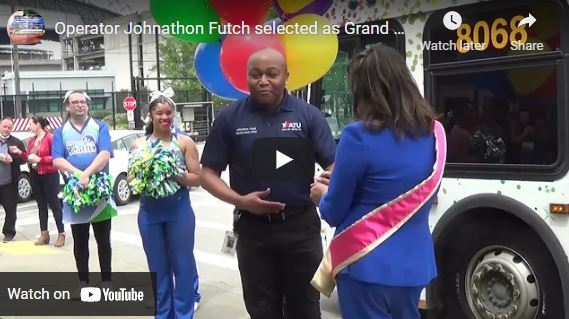 screenshot of the YouTube video where Jonathon Futchs is in front of the print bus receiving the Grand Marshall sash