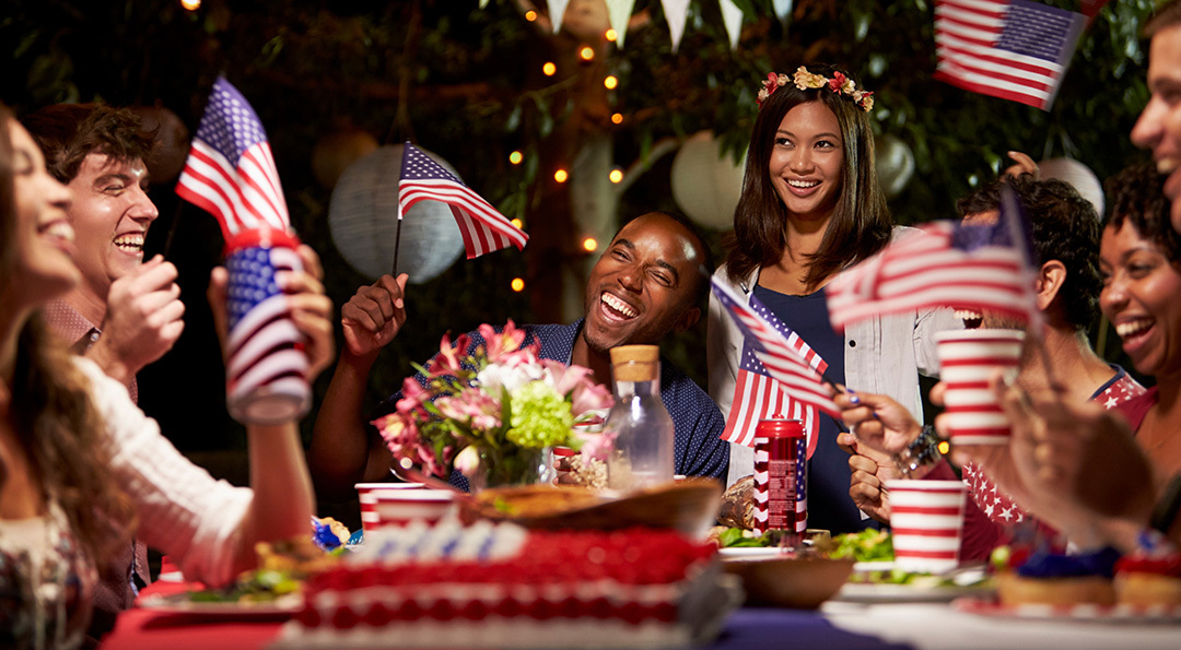 Backyard party with food, flowers, and flags