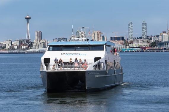 Image of Water Taxi crossing Elliot Bay with the skyline of Seattle in the background 
