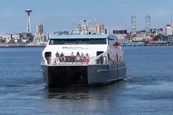 Image of Water Taxi crossing Elliot Bay with the skyline of Seattle in the background 