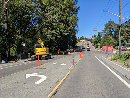 Temporary orange posts help prevent traffic from using the center lane of Renton Ave. S during construction