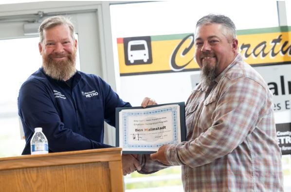 EOY award is presented to facilities lead Ben Malmstadt, right, at Atlantic Base operations in Seattle, WA. on Oct. 4,  by Curtis Dickey, 