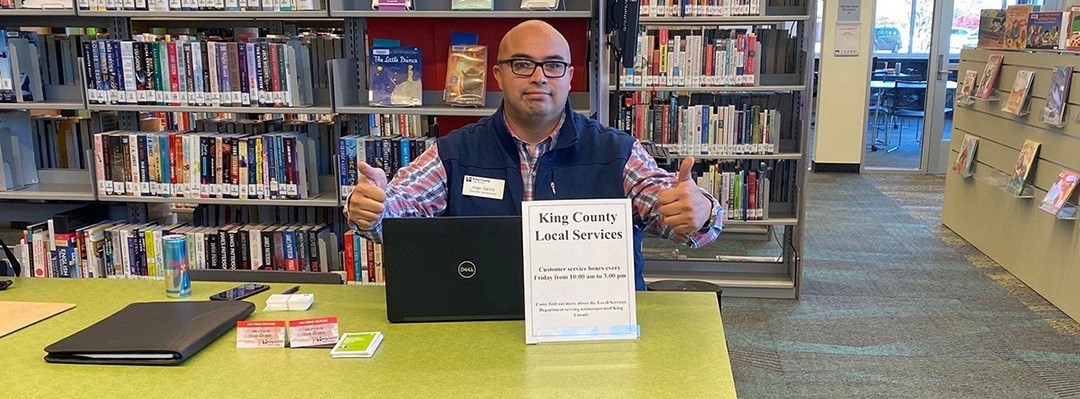 DLS Economic Development Program Manager Hugo Garcia ready to provide services at the Fall City Library.