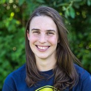 Straight on portrait photo of white woman with straight brown shoulder length hair and brown eyes
