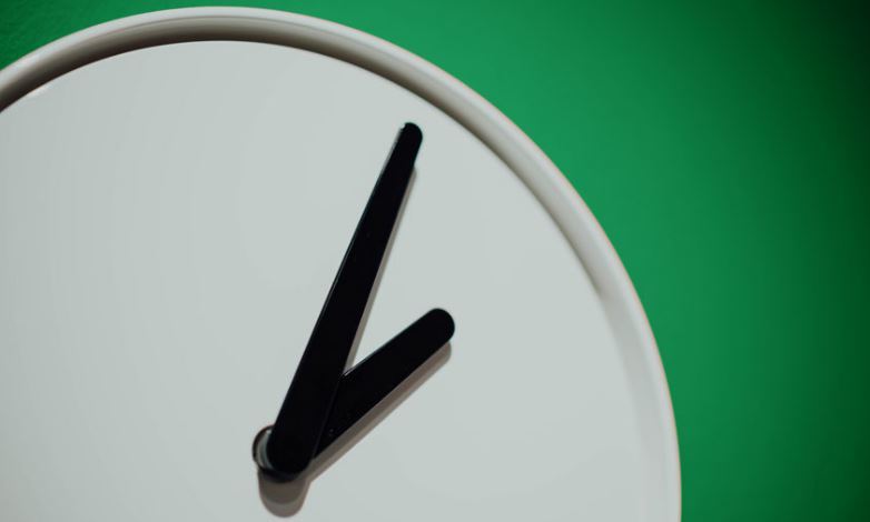White clock face on green background