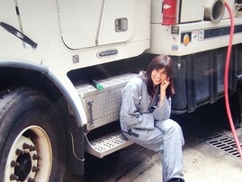 Woman sitting on a large industrial truck