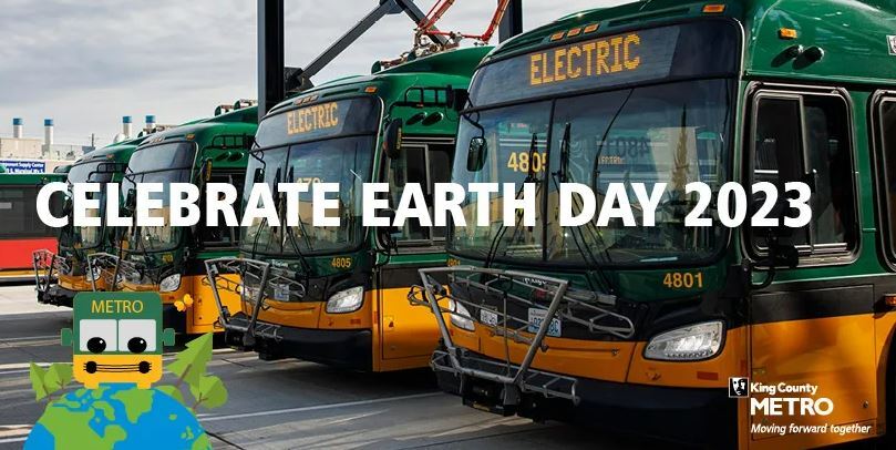 Row of battery electric coaches behind text that reads, "Celebrate earth day 2023