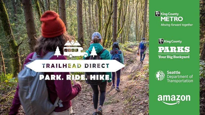 Image of hikers in the woods with Trailhead Direct Logo and logos for SDOT, KCM, King county Parks and Amazon