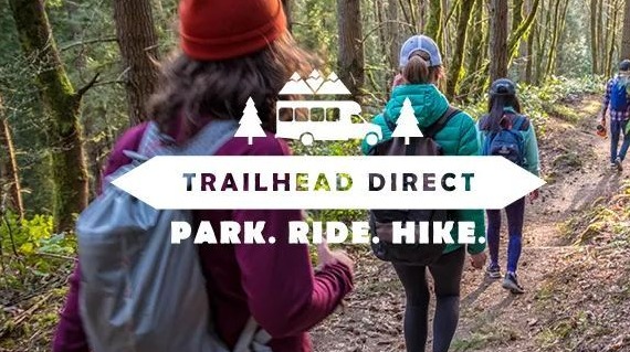 Image of hikers in the woods with Trailhead Direct Logo and logos for SDOT, KCM, King county Parks and Amazon