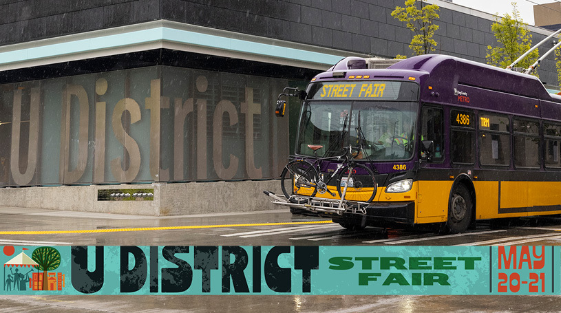 image of a metro bus and the text " U District street fair May 20-12"
