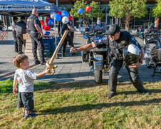 Deputy playing with child during National night out event.