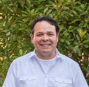 A man smiles at the camera