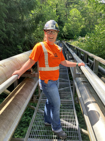 Lizzy Corliss poses on a bridge in her protective gear.