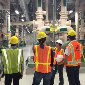 A group of people in reflective vests tour the Brightwater facility.